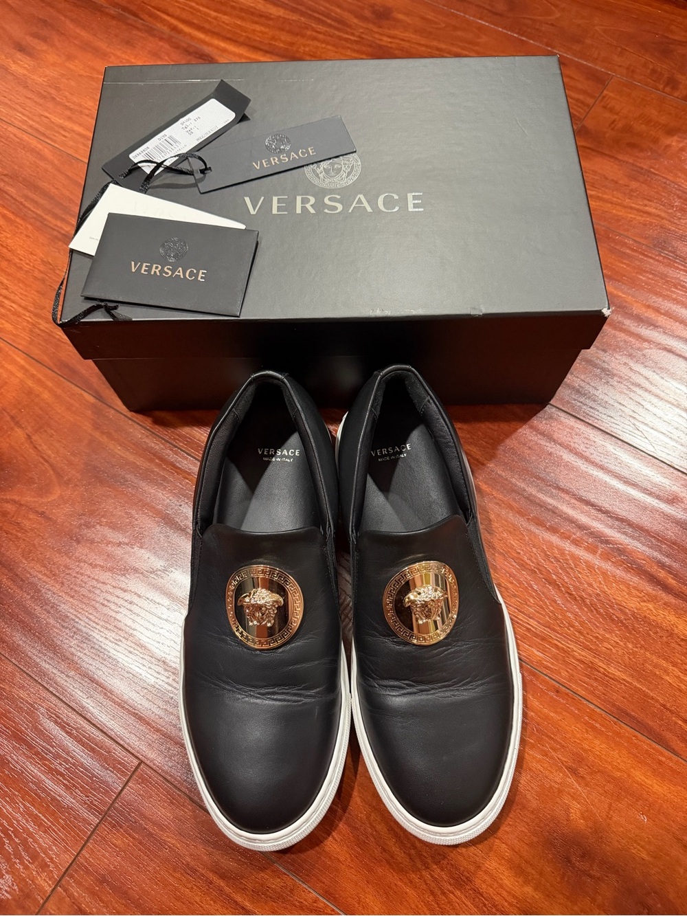 Versace Black Leather Slip-On Women Sneakers with Gold Medallion Accents